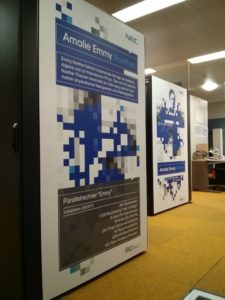 sideview of serverracks in the serverroom, with posters about Emmy Noether