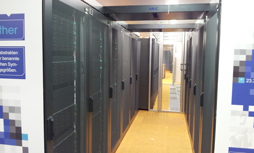 Aisle in the serverroom with racks full of servers on both sides