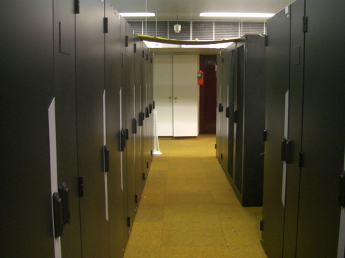 Aisle in the serverroom with racks full of servers on both sides